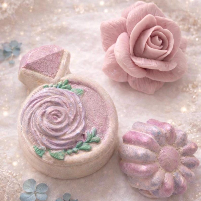 Handmade rose soap and decorative bath bombs from a luxury spa gift box arranged on a soft pastel background.