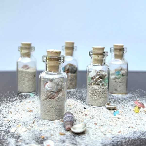 Tiny glass bottle with beach theme, shells, sand, sea glass