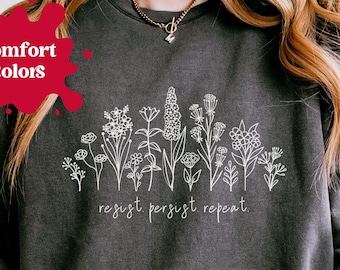 Camiseta de resistência, camiseta de protesto, moletom ativista, camiseta de gola redonda "Resistir, persistir, repetir", estampa retrô anti-Trump, estampa floral em defesa dos direitos das mulheres.