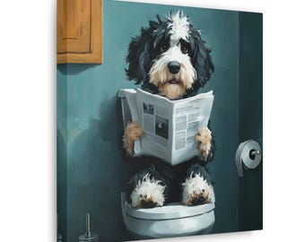 May include: A black and white dog sits on a white toilet, reading a newspaper. The dog is wearing a black and white collar and has a white muzzle. The bathroom is painted a teal blue color.