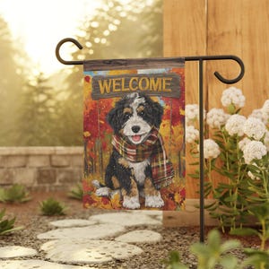 May include: A garden flag featuring a cute puppy wearing a plaid scarf, set against a backdrop of autumn leaves. The flag has a wooden sign that reads "WELCOME". The flag is displayed on a black metal stand.