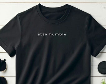 May include: Black t-shirt with white text that reads "stay humble."