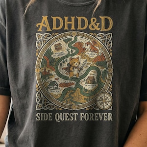 T-shirt with "ADHD&D SIDE QUEST FOREVER" and circular graphic with creatures and text.
