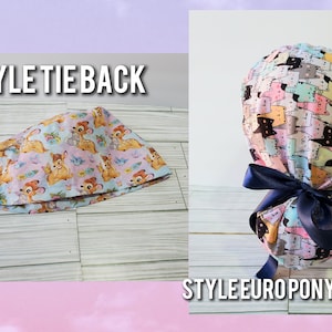 May include: Two surgical caps with different tie back styles. The cap on the left has a tie back and is made of a light blue fabric with a pink and white pattern of deer. The cap on the right has a euro ponytail style tie back and is made of a light blue fabric with a pink, white, and black pattern of cats.
