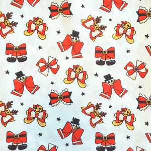 May include: A repeating pattern of Christmas-themed bows and characters on a white background. The bows are red, white, and black, with some featuring snowman, gingerbread, and reindeer designs. Small black stars are scattered throughout.