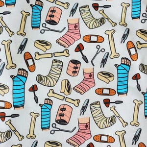 May include: A white background with a repeating pattern of medical supplies and broken bones. The pattern includes bandages, casts, crutches, bone fragments, and medical tools. The pattern is in shades of blue, pink, yellow, and brown.