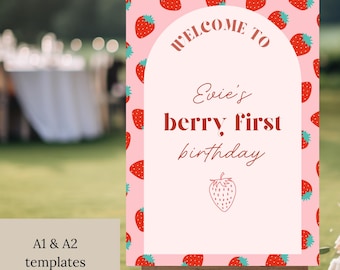 Puede incluir: Un letrero rosa sobre un caballete con el texto "Welcome to Evie's berry first birthday". El letrero está decorado con fresas rojas y una ilustración de fresa. Se incluyen plantillas A1 y A2.