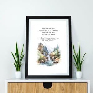 May include: A watercolor painting of a waterfall in a mountain landscape. The painting is framed in black and has a quote in French that reads: "BIEN-AIMÉ DE DIEU, AUJOURD'HUI, TU ES ENGENDRE. BIEN-AIMÉ DE DIEU, LE PÈRE T'A DONNÉ tout son amour"