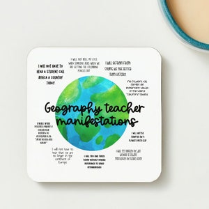 May include: A white coaster with a watercolor illustration of the Earth. The text "Geography teacher manifestations" is written in black cursive font. The coaster features a list of humorous statements about geography teachers, such as "I will not have to hear a student call Africa a country today" and "I will not be tempted by a planet sketch cup".