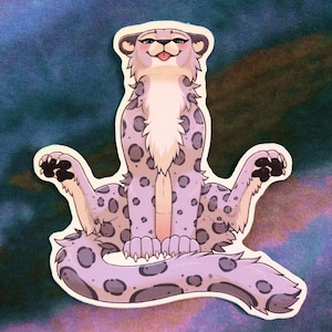 Puede incluir: Una pegatina de leopardo de las nieves de dibujos animados de color morado y blanco con un patrón de manchas. El leopardo está sentado con las patas extendidas y la cola enroscada alrededor de su cuerpo. Tiene una expresión juguetona en su rostro.