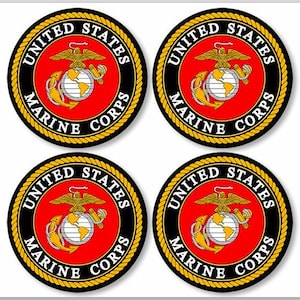 May include: Four round stickers with the United States Marine Corps emblem. The emblem features a red background with a gold eagle, globe, and anchor. The words "United States Marine Corps" are written in a black circle around the emblem.