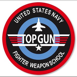 May include: A red, white and blue circular patch with the text "United States Navy Top Gun Fighter Weapon School". A white silhouette of a fighter jet is in the centre of the patch.