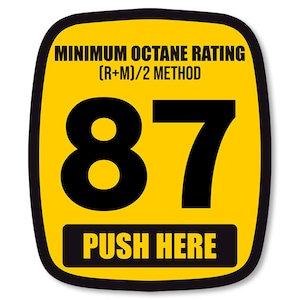 May include: Yellow sticker with black text and border. It reads "MINIMUM OCTANE RATING (R+M)/2 METHOD 87 PUSH HERE".