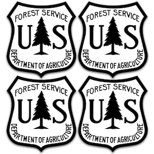 May include: Four black and white stickers with the United States Forest Service logo. The logo features a stylized pine tree with the letters "UAS" and the text "FOREST SERVICE DEPARTMENT OF AGRICULTURE".