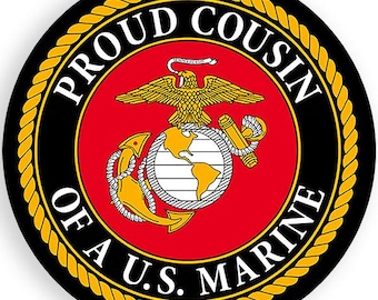 May include: A round, black and gold sticker with the words "Proud Cousin of a U.S. Marine" in a white circle. The centre of the sticker features the official emblem of the United States Marine Corps.