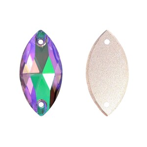 May include: Two marquise-shaped sew-on crystals. The left crystal features a faceted surface with iridescent purple and green hues and two circular holes. The right crystal shows the flat, textured, light-colored back with two holes.