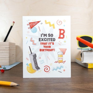 May include: A birthday card with a 90s theme featuring a retro phone, a pill bottle, and the text "I'm so excited that it's your birthday!"