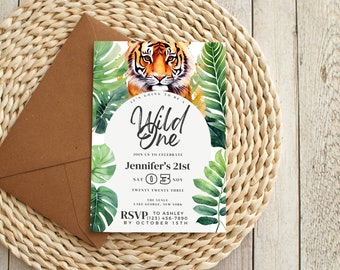 May include: A white invitation with a watercolor illustration of a tiger and tropical leaves. The text reads "It's going to be a Wild One, Jennifer's 21st, Sat 03 Nov Twenty Twenty Three, The Venue, Lake George, New York, RSVP to Ashley (123) 456-7890 by October 15th."