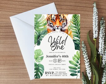 May include: A jungle-themed invitation with a watercolor illustration of a tiger and tropical leaves. The text reads "It's going to be a Wild One. Join us to celebrate Jennifer's 40th. Sat 05 Nov Twenty Twenty Three. The Venue Lake George, New York. RSVP to Ashley (123) 456-7890 by October 15th."