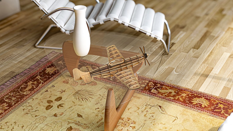 May include: A wooden model airplane sits on a glass coffee table with a wooden base. The table is on a rug with a floral pattern. A white vase sits on the table.