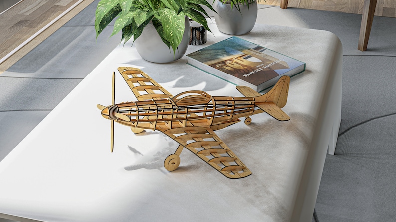 May include: A wooden model airplane with a detailed, open-frame design. The model is made of light brown wood and has a propeller on the front.