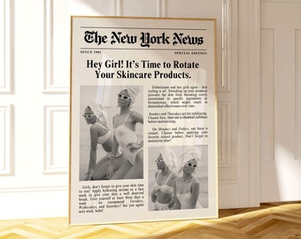 May include: A framed print designed to look like a newspaper front page. The headline reads "Hey Girl! It's Time to Rotate Your Skincare Products." The image features a black and white photo of women in swimwear and sunglasses.