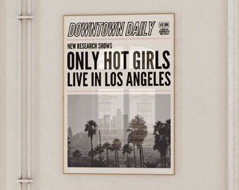 May include: A framed poster with the headline "ONLY HOT GIRLS LIVE IN LOS ANGELES" in bold black letters. The poster features a black and white image of palm trees and a cityscape. The poster is in a gold frame.