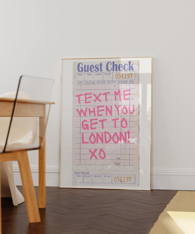 May include: A framed print of a vintage guest check with the text "TEXT ME WHEN YOU GET TO LONDON! XO" written in pink on a white background.