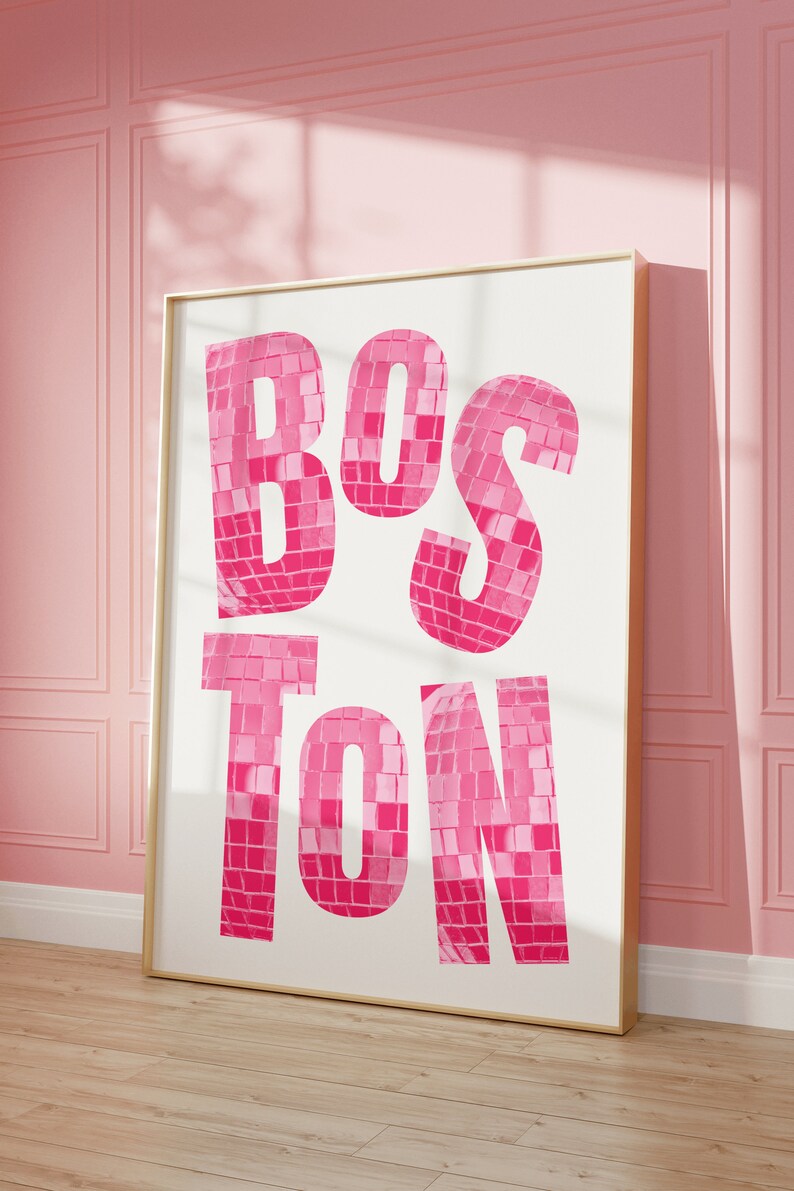 May include: A framed print with the word "BOSTON" in large, pink letters. The letters are made up of small, pink squares, resembling a disco ball.