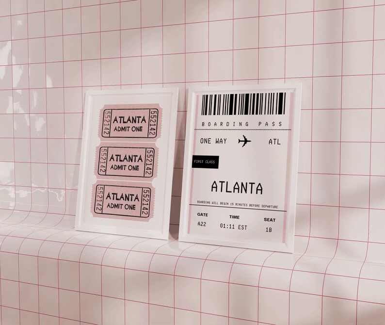 May include: A white framed picture with three tickets for admission to Atlanta. The tickets are printed with the text "Atlanta Admit One" and the number "552142".  A white framed picture with a boarding pass for a one-way flight to Atlanta. The boarding pass is printed with the text "Boarding Pass", "One Way", "ATL", "First Class", "Atlanta", "Gate A22", "Time 01:11 EST", and "Seat 18".