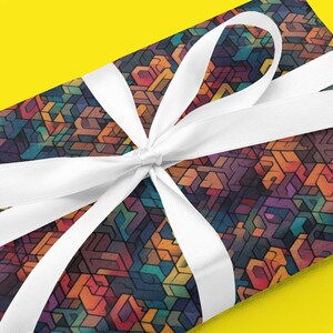 May include: A gift box wrapped in colorful geometric patterned paper with a white satin ribbon tied in a bow.