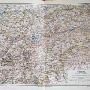 Könnte beinhalten: Antike Karte von Tirol, Österreich, mit detaillierten geografischen Informationen. Die Karte ist auf gealtertem Papier mit Sepia-Ton gedruckt und zeigt Berge, Flüsse und Städte. Der Titel "TIROL" ist sichtbar, zusammen mit einem Maßstab und kartografischen Details.