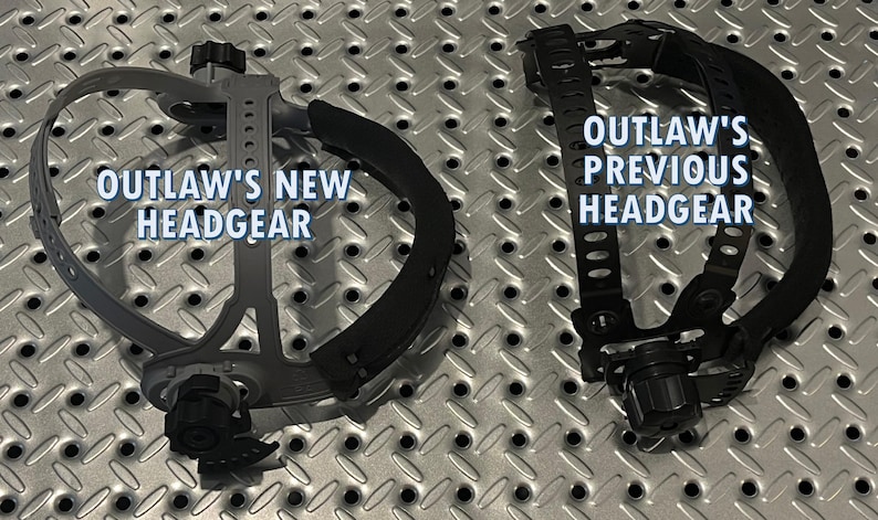 May include: Comparison of two headgear designs. On the left, a gray headgear labeled "OUTLAW'S NEW HEADGEAR." On the right, a black headgear labeled "OUTLAW'S PREVIOUS HEADGEAR." Both are set against a textured, metallic background.