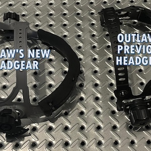 May include: Two welding headgear units are displayed on a textured metal surface. The left unit is gray and labeled "OUTLAW'S NEW HEADGEAR." The right unit is black and labeled "OUTLAW'S PREVIOUS HEADGEAR."