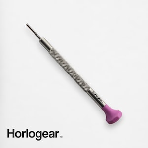May include: A silver watch repair tool with a pink handle and the text "Horlogear" printed on the side.