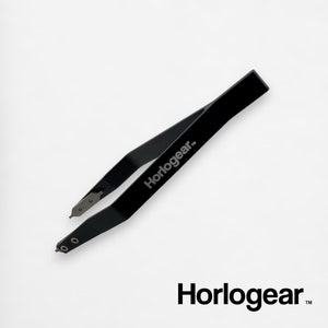May include: Black metal tweezers with a curved design and a pointed tip. The tweezers are labeled "Horlogear" on the handle.