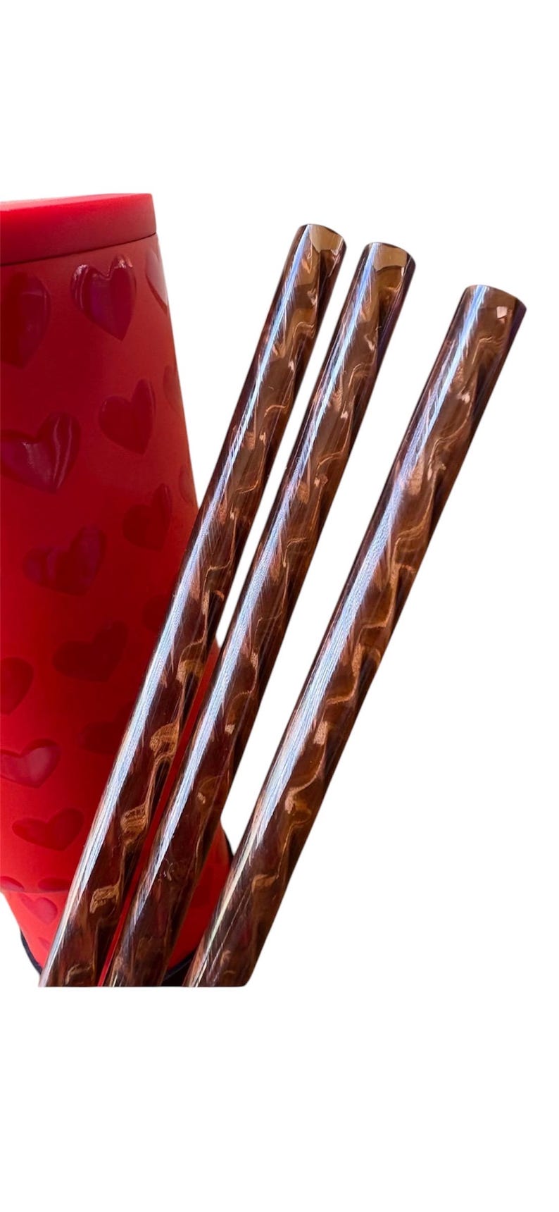 May include: Three brown and gold striped drinking straws.