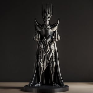 May include: A black 3D printed figurine of a dark lord wearing a crown and armor. The figurine is standing on a black base.