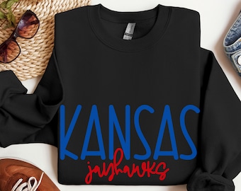 May include: Black sweatshirt with the words "KANSAS jayhawks" in blue and red lettering.
