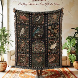 May include: A dark woven throw blanket with a repeating pattern of squares, each featuring a different animal or bird. The blanket has a fringed edge and the text "Crafting Memories, One Gift at a Time."
