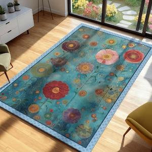 May include: A rectangular area rug with a floral design. The rug features large, colorful flowers in shades of red, pink, purple, and yellow against a turquoise background. The rug has a patterned border and is placed on a wooden floor.