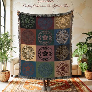 May include: A woven throw blanket with a geometric pattern of circles in various colors, including green, red, and blue. The blanket has a fringed edge and the text "Crafting Memories, One Gift at a Time."