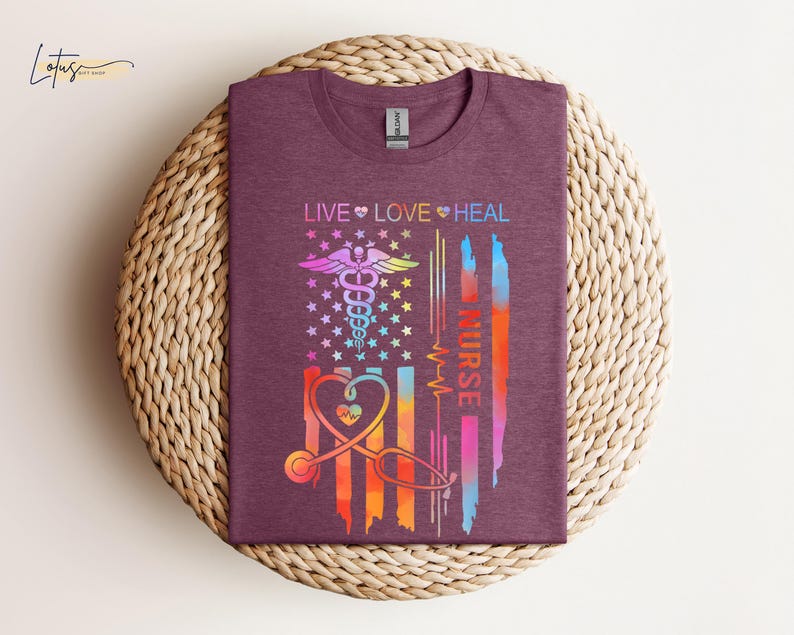 May include: A maroon t-shirt with a colorful American flag design. The flag has a medical caduceus symbol and the words "Live Love Heal Nurse".