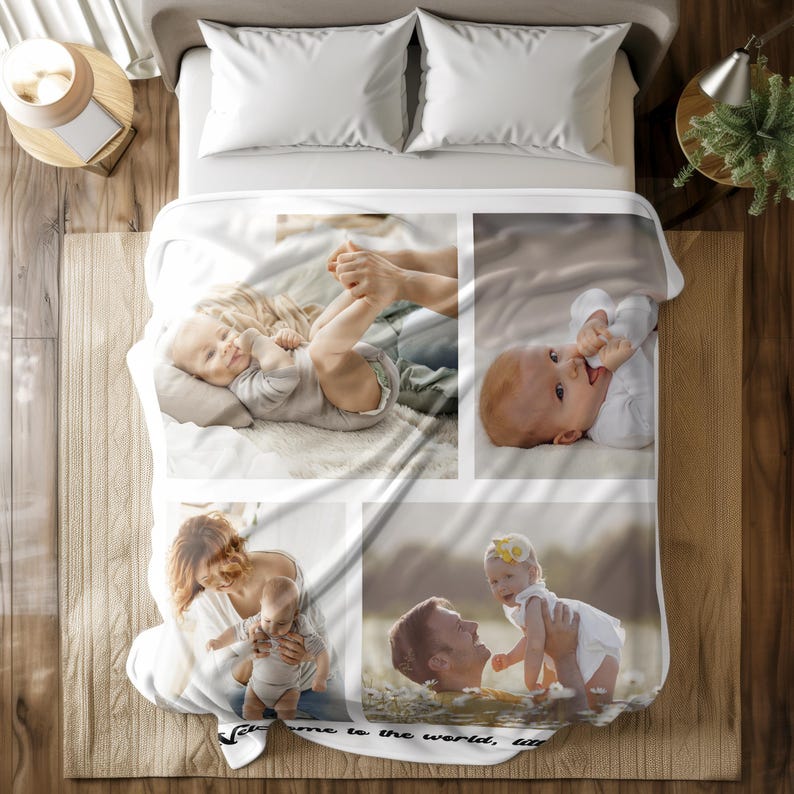 May include: White baby blanket featuring four photo panels of babies and adults. The blanket has the text "Welcome to the world, little one" printed on it. The blanket is on a bed with white pillows.