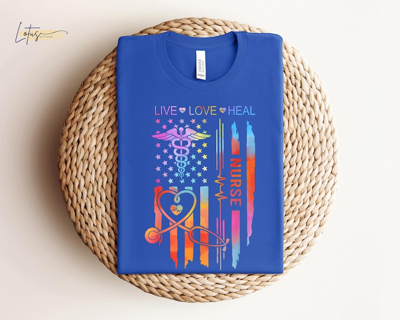 May include: A blue t-shirt with a rainbow-colored American flag design. The flag features a caduceus, a heart, and the text "Live Love Heal Nurse".