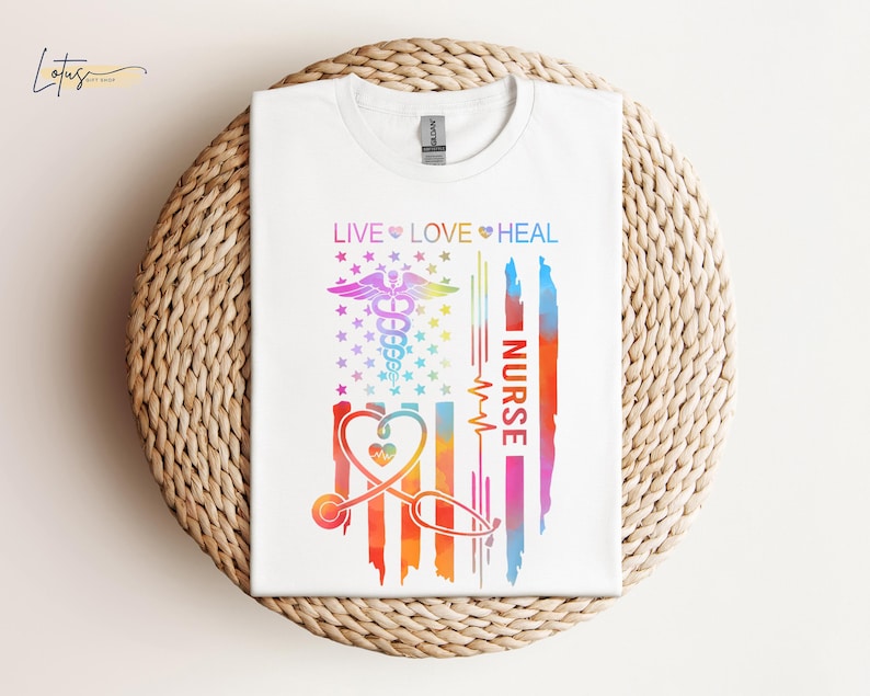 May include: White t-shirt with a rainbow-colored American flag design. The flag has a stethoscope, a heart, and the words "Live Love Heal Nurse".