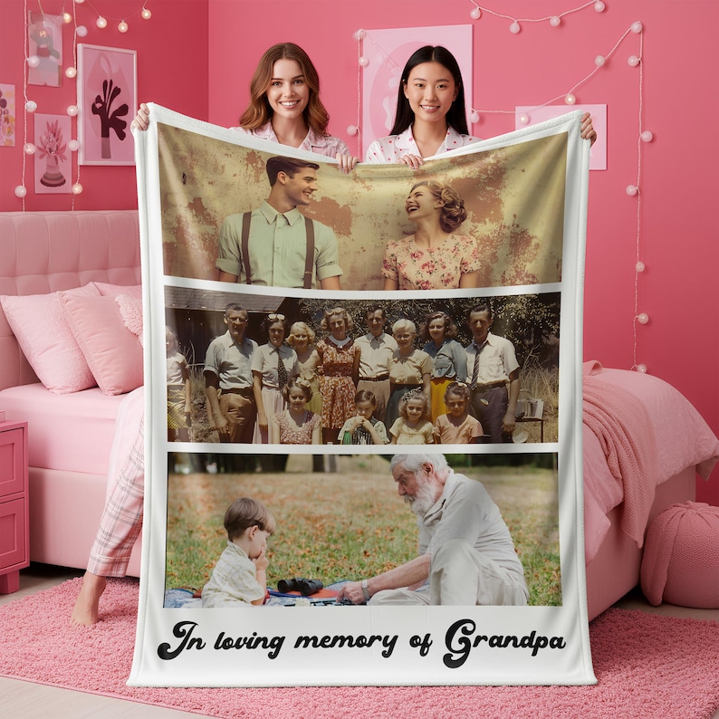 May include: A personalized photo blanket featuring three family photos. The blanket has a white border and the words "In loving memory of Grandpa" in black script at the bottom. Two women are holding the blanket in front of a pink background.