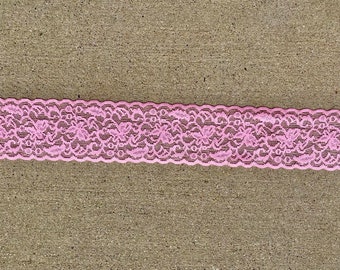 May include: Pink lace trim with a floral pattern.