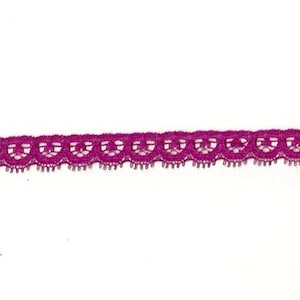 May include: A close-up of a purple lace trim with a scalloped edge.