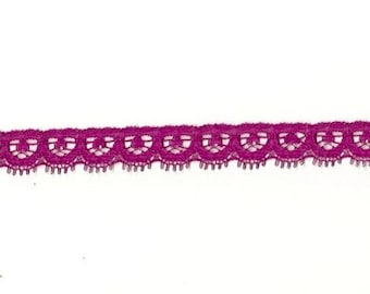 May include: A close-up of a purple lace trim with a scalloped edge.